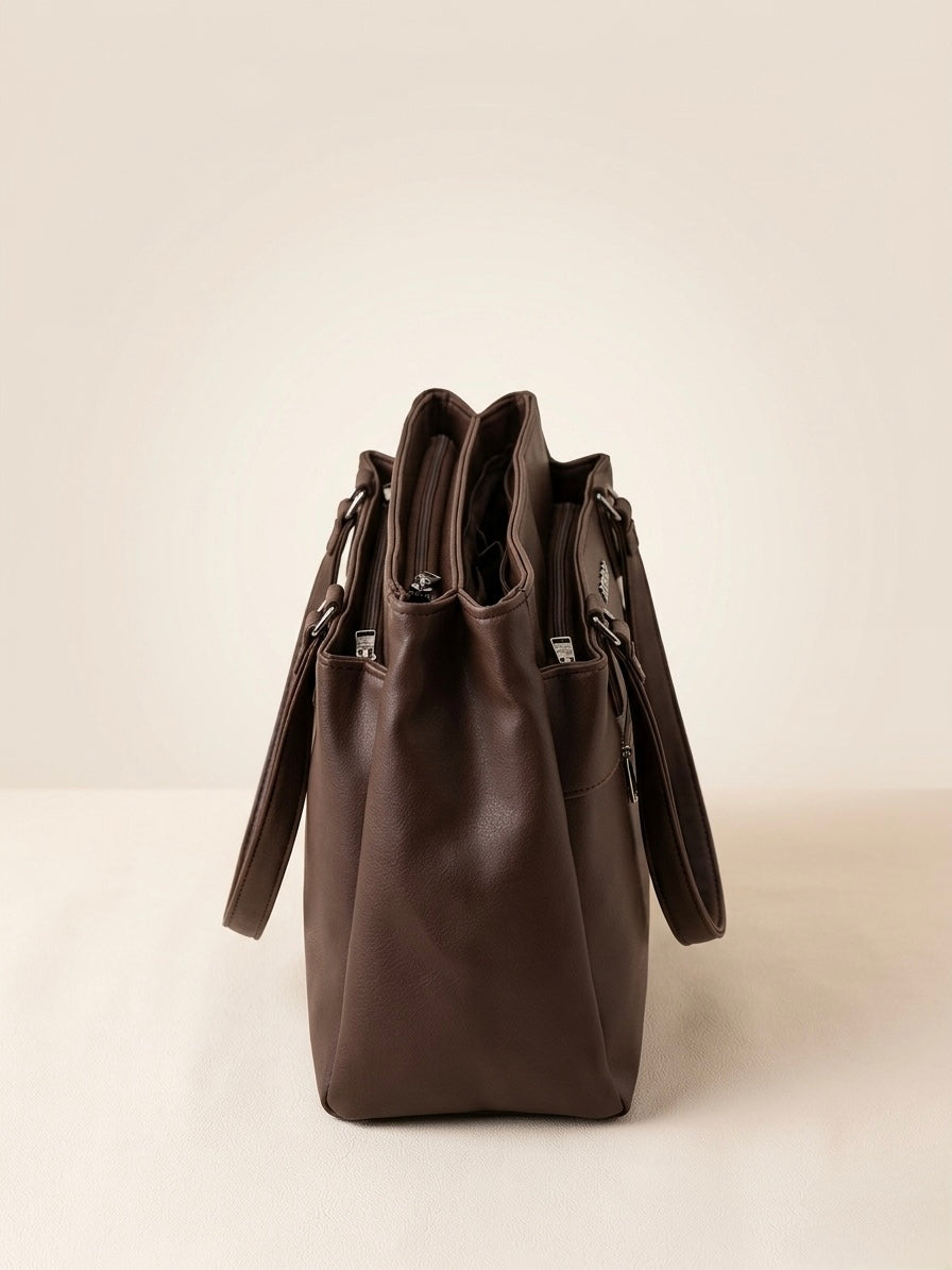 Brown leather handbag on a light beige background