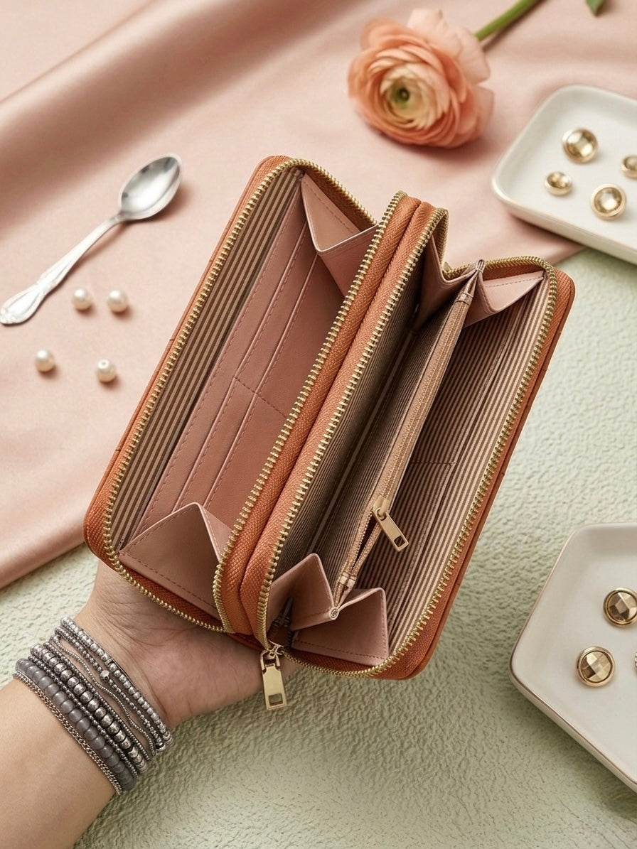 Open beige wallet on a light green surface with a pink cloth and decorative items in the background.