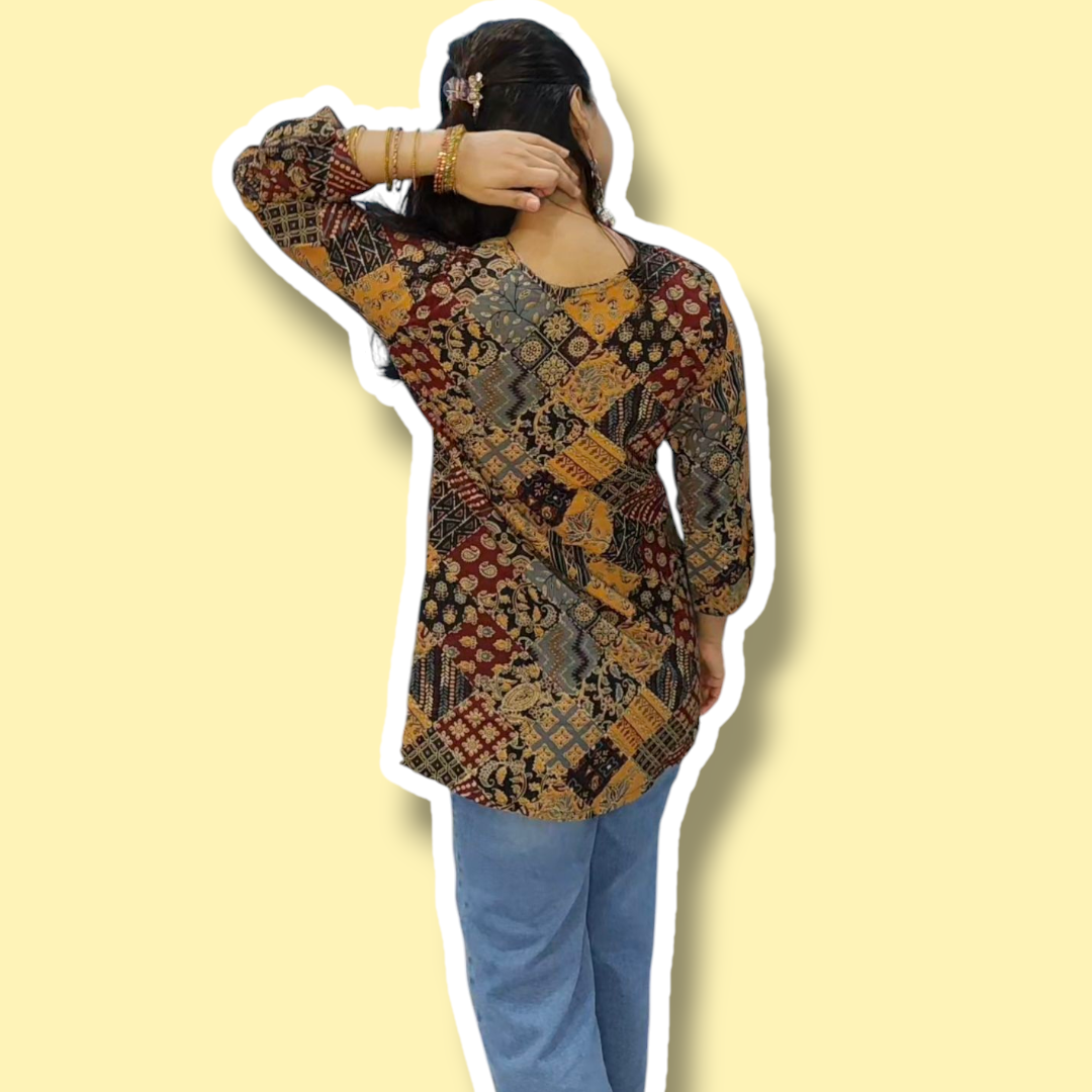 Woman wearing a patterned top and blue jeans on a yellow background