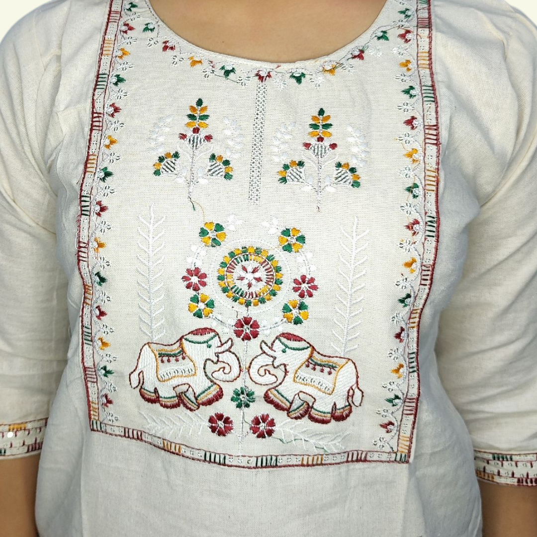 White embroidered top with colorful patterns on a plain background