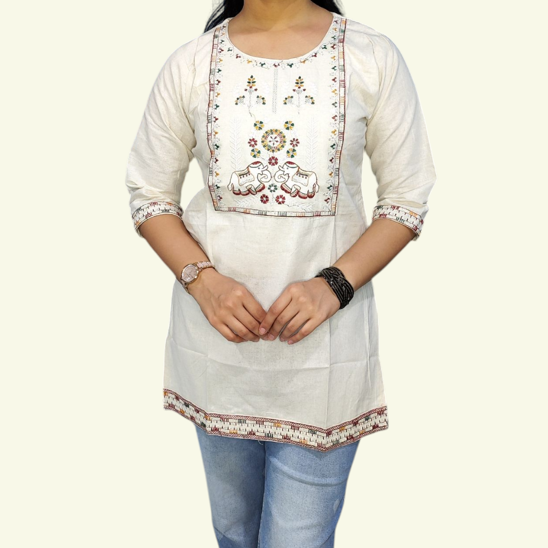 White embroidered kurta worn by a person on a white background