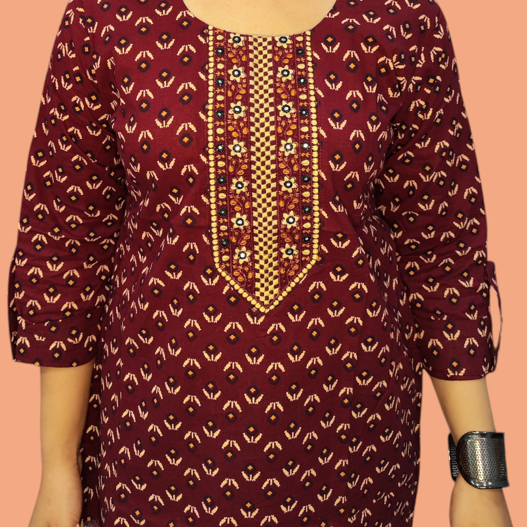 Maroon traditional dress with gold and black patterns on a peach background