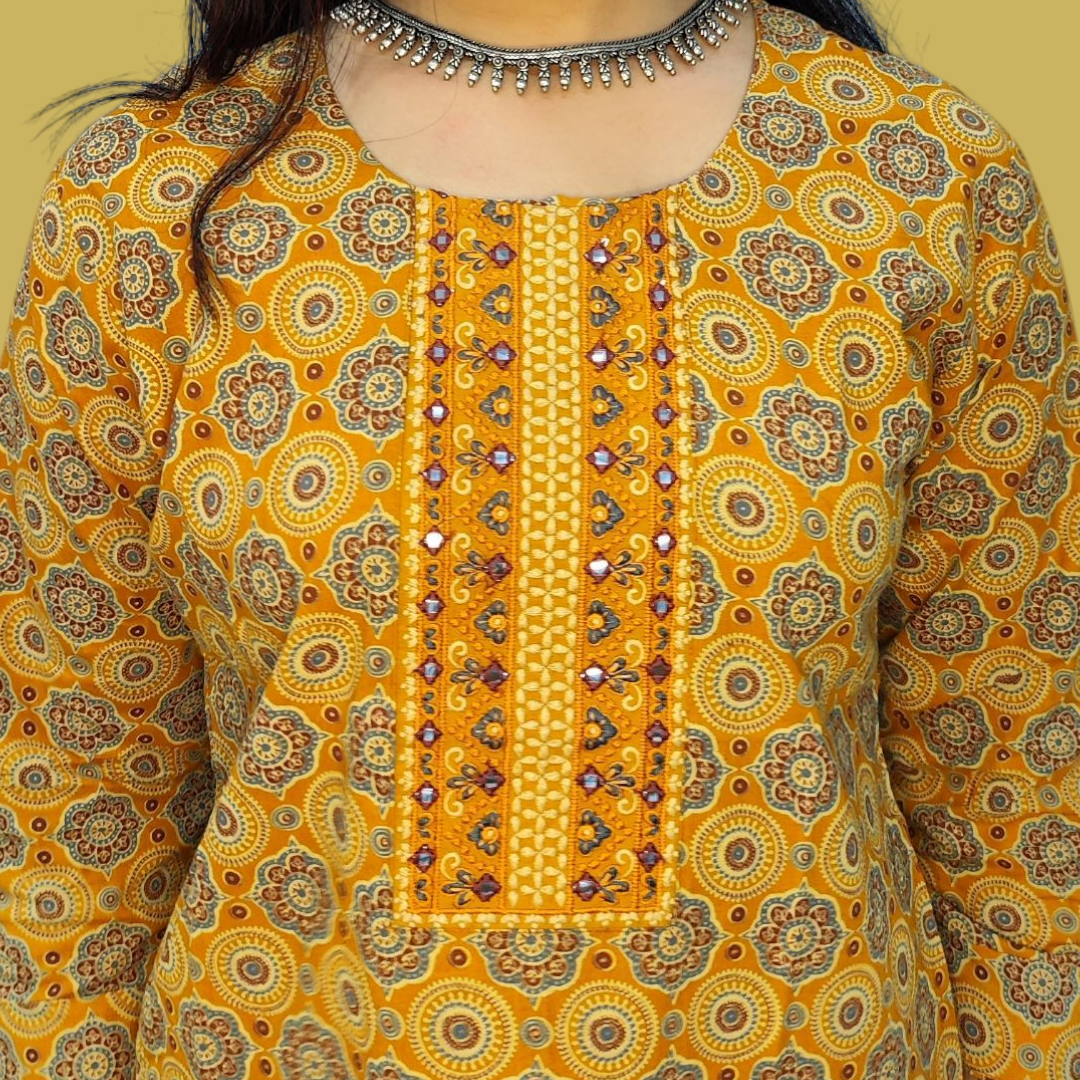 Yellow patterned shirt with intricate design and embellishments